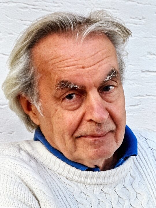 Portret van Roel van Duijn in een witte trui, voor een witte muur